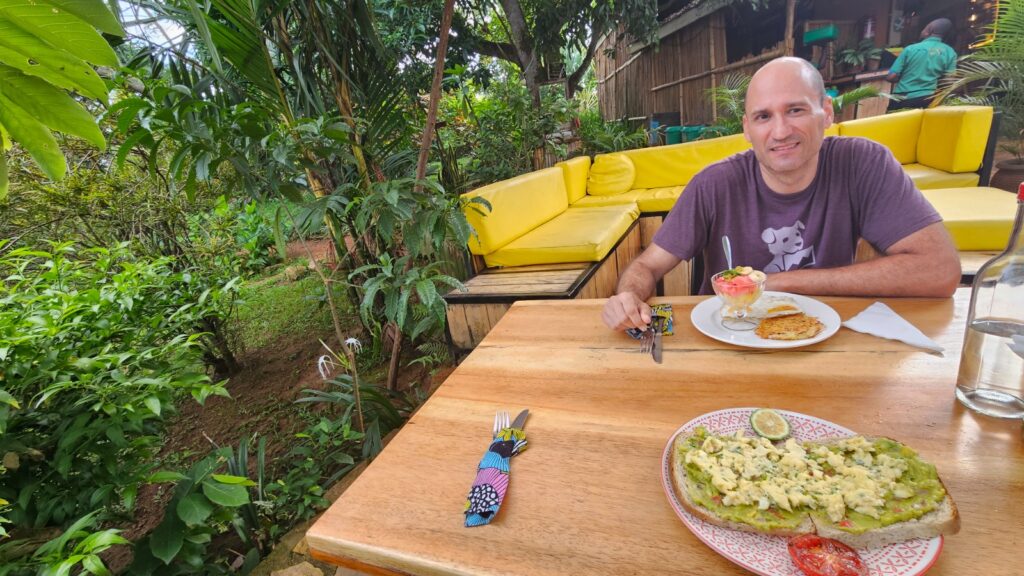 Enjoying breakfast in hostel Via Via in Entebbe, during our trip to the Uganda Marathon in 2025