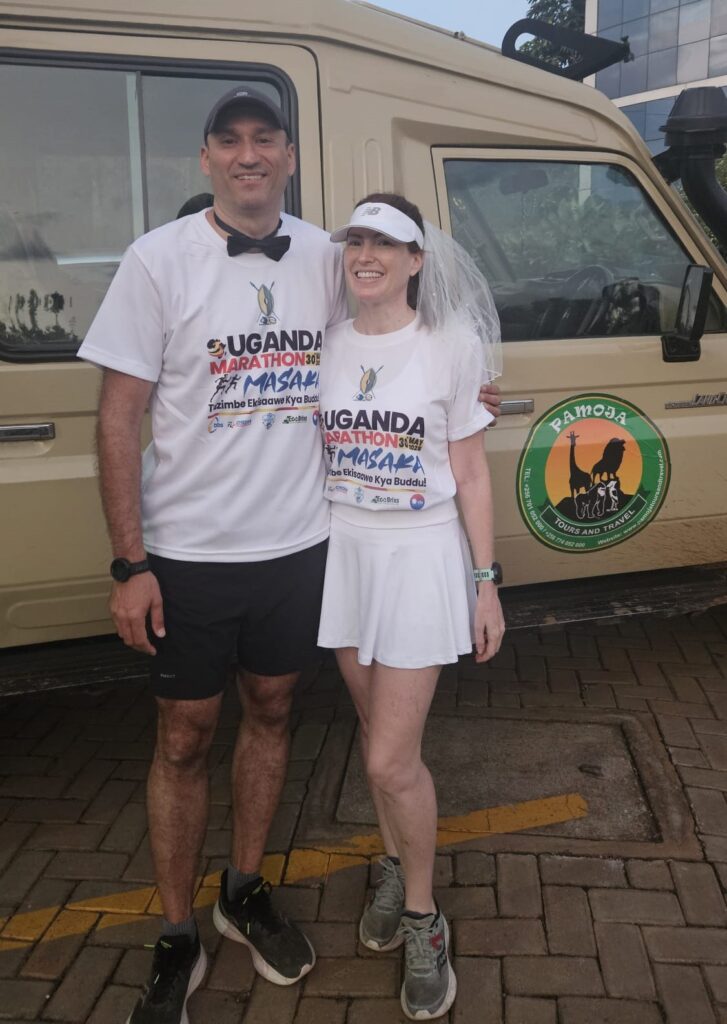 Running the Uganda Marathon in Masaka, Uganda, in May 2025, for our honeymmon, dressed as bride and groom.