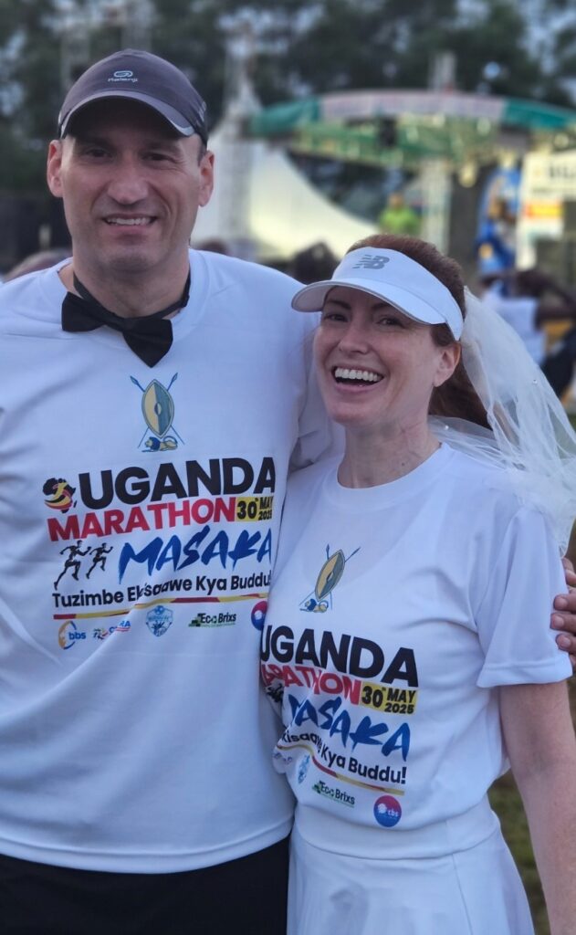 Running the Uganda Marathon in Masaka, Uganda, in May 2025, for our honeymmon, dressed as bride and groom. Starting line.