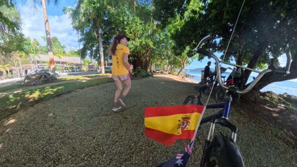 The running ginger running in Port Vila, Vanuatu. 6k run and a Spanish flag on a kid's bicycle.