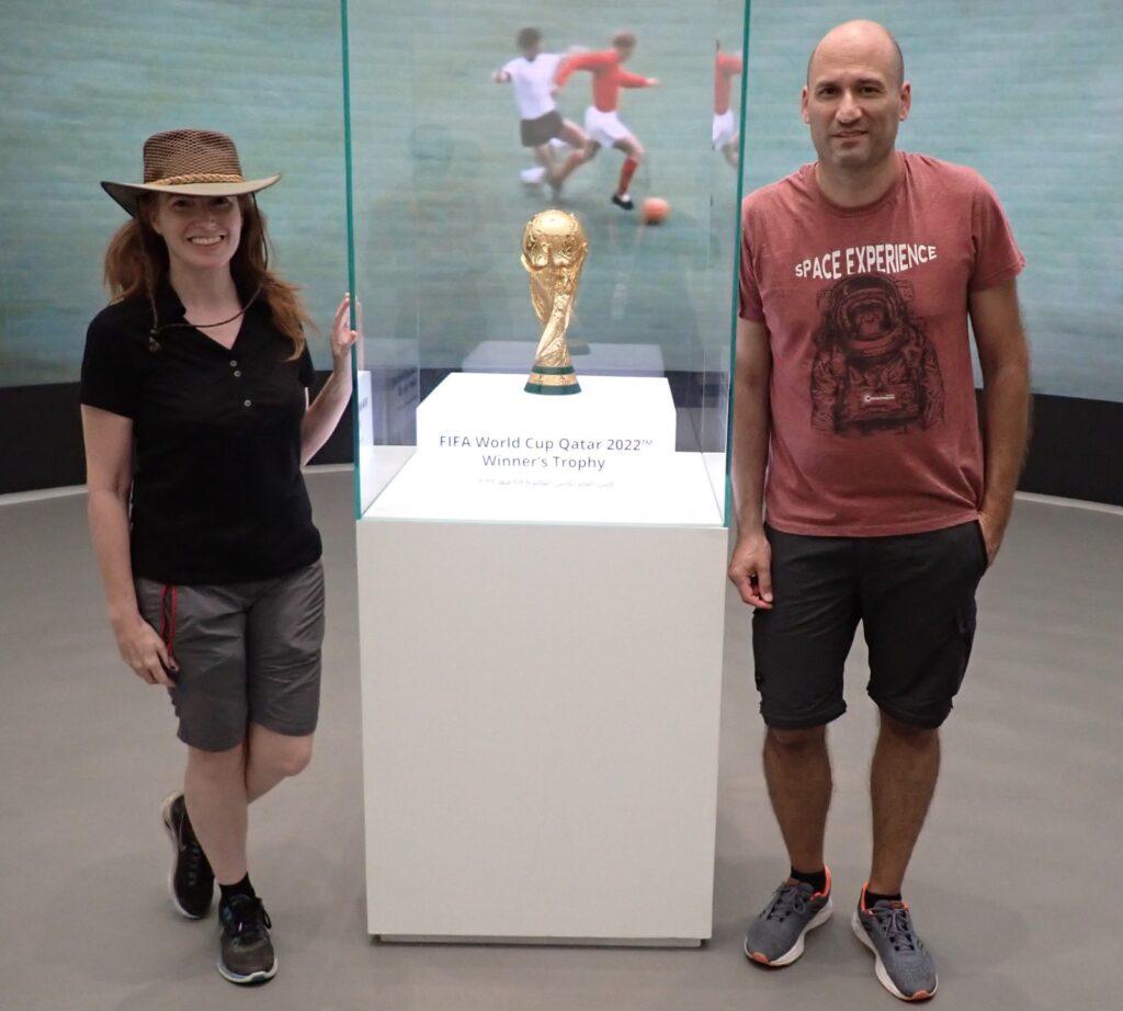 The running giner in Qatar for the FIFA World Cup 2022. With the real FIFA football trophy, in an exhibition.