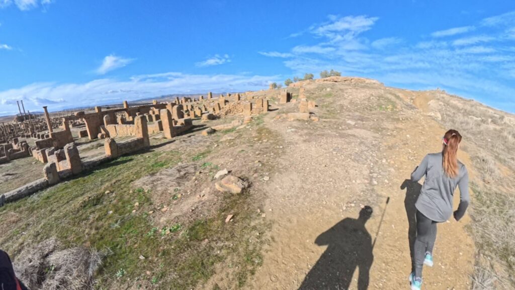 The running ginger running inside the ruins of Timgad, Argelia, in 2026. Recommended route for running and experiencing history at the same time.