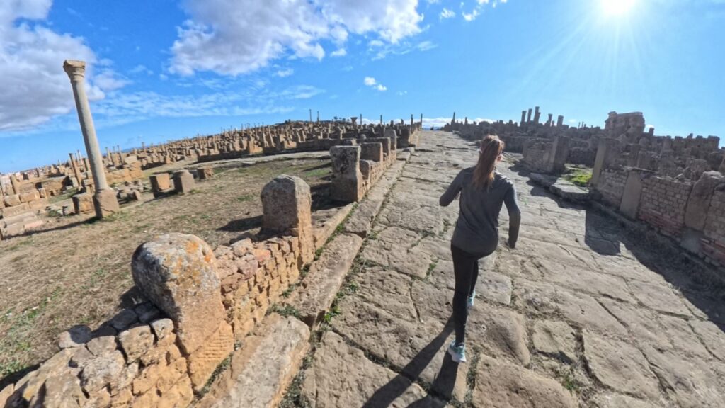 The running ginger running inside the ruins of Timgad, Argelia, in 2026. Recommended route for running and experiencing history at the same time.
